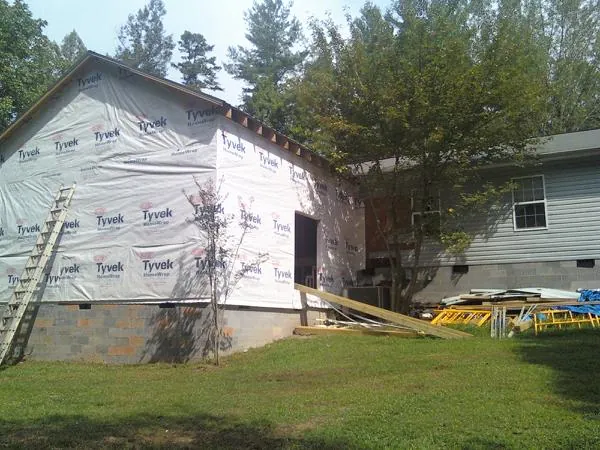 Tyvek wrapped gable on a new room addition beside an existing home in Wilson Creek